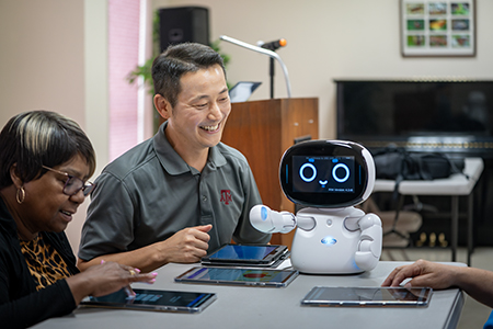 Dr. Junhyoung (Paul) Kim with robot.